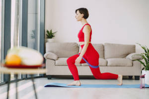 Canva Sportswoman doing stretching exercise on mat