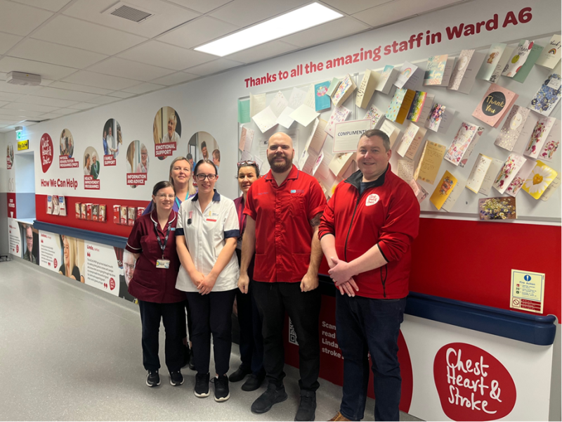 <p>Staff from the stroke ward in Antrim Area Hospital with one of the NICHS information walls.</p>