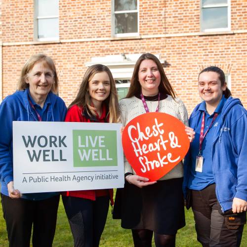 Rebecca Hawkins Workplace Health and Wellbeing Co ordinator at Northern Ireland Chest Heart Stroke and Ashley Bolton Employment Officer at Stepping Stones NI with Stepping Stones NI staff