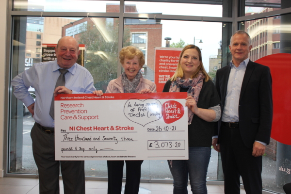 Charlie Geraldine and Nicola Connolly present cheque to NICHS Chief Executive Declan Cunnane